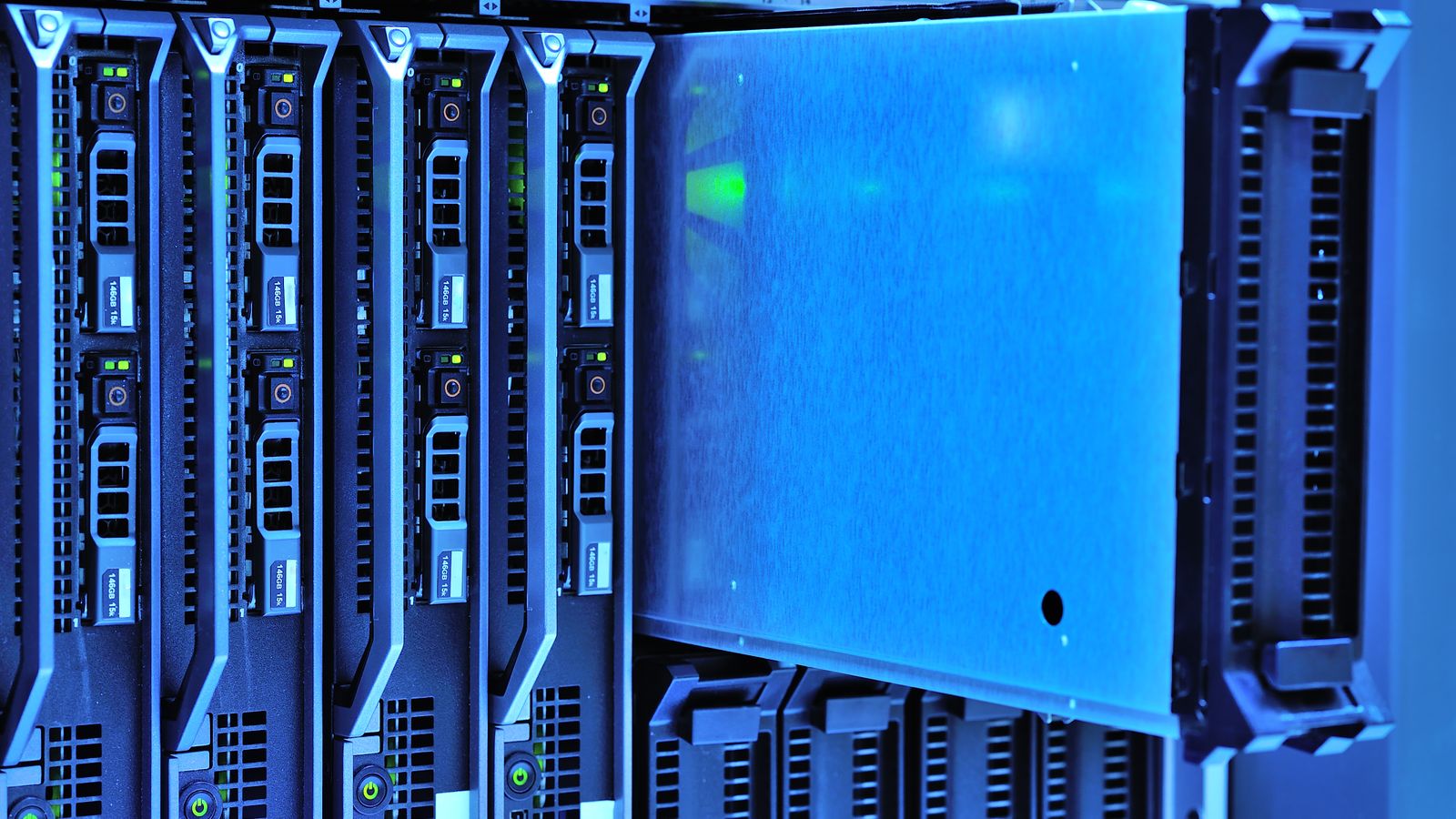 Close view of blue-lit blade servers in a rack